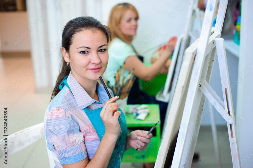 beautiful young girls draws a picture paints on art lesson beautiful young girls draws a picture paints on art lesson