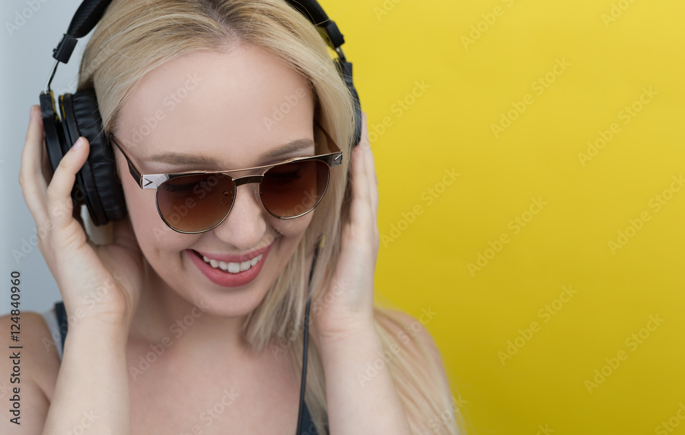 Fototapeta premium Young woman with headphones listening music and having funn. Blo