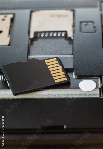 Micro SD card and memory slot on smart phone. selective focus.