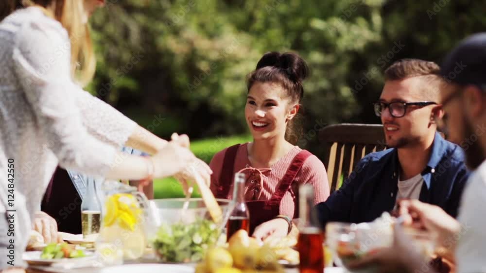 happy friends having dinner at summer garden party happy friends having dinner at summer garden party