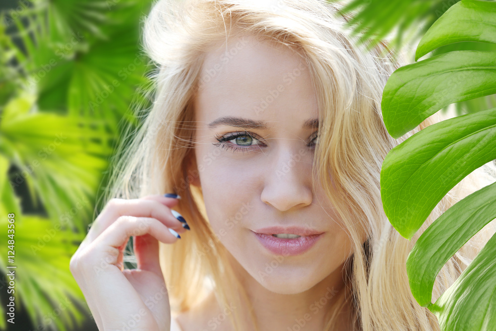 Beautiful young woman and green foliage, closeup Beautiful young woman and green foliage, closeup