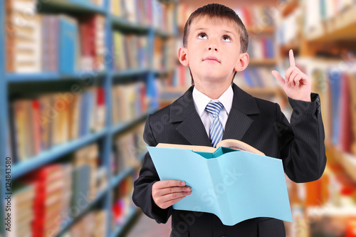 Cute little boy with book o...