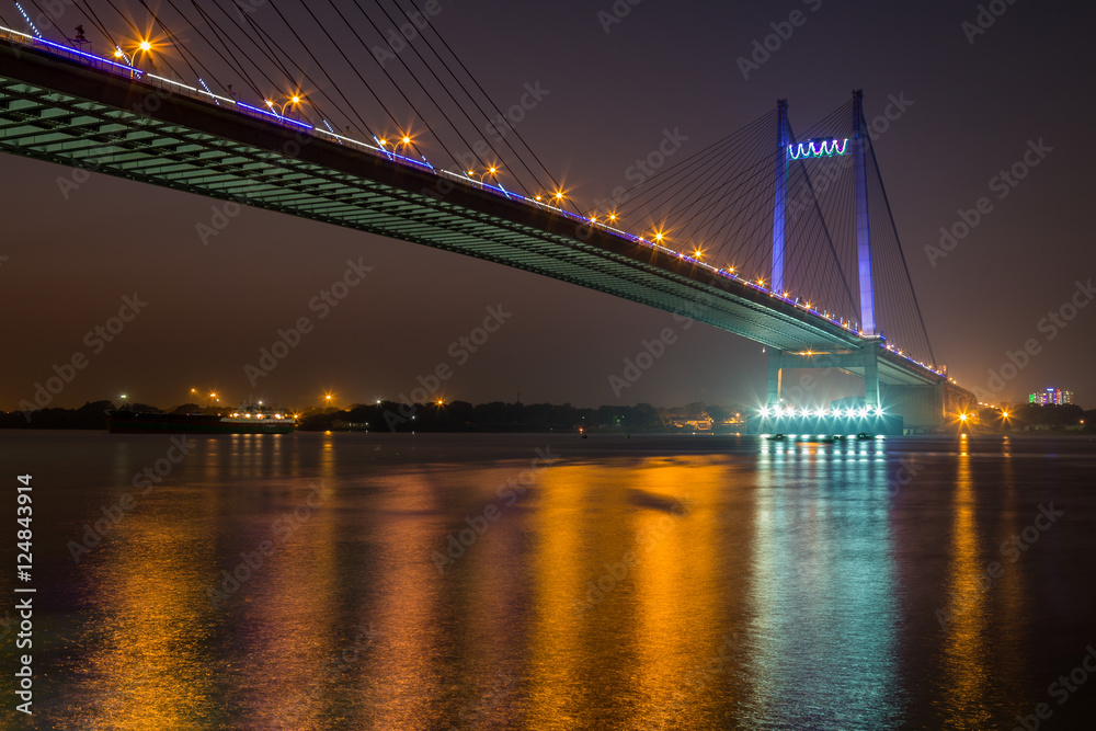 Vidyasagar bridge (Setu) on river Hooghly under night illumination, Kolkata India.