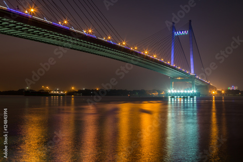 Vidyasagar bridge (Setu) on river Hooghly under night illumination, Kolkata India.