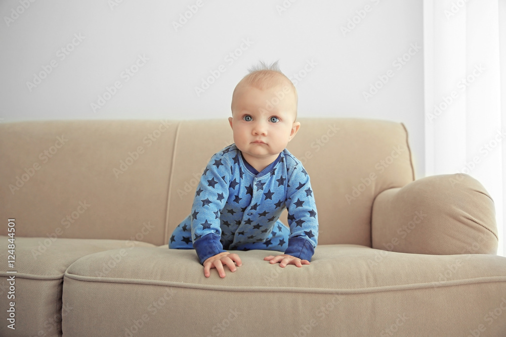 Adorable little baby crawling on sofa Adorable little baby crawling on sofa