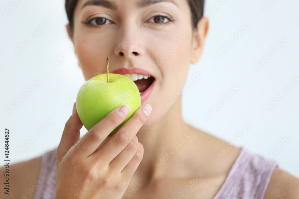 Young woman eating green apple, close up Young woman eating green apple, close up