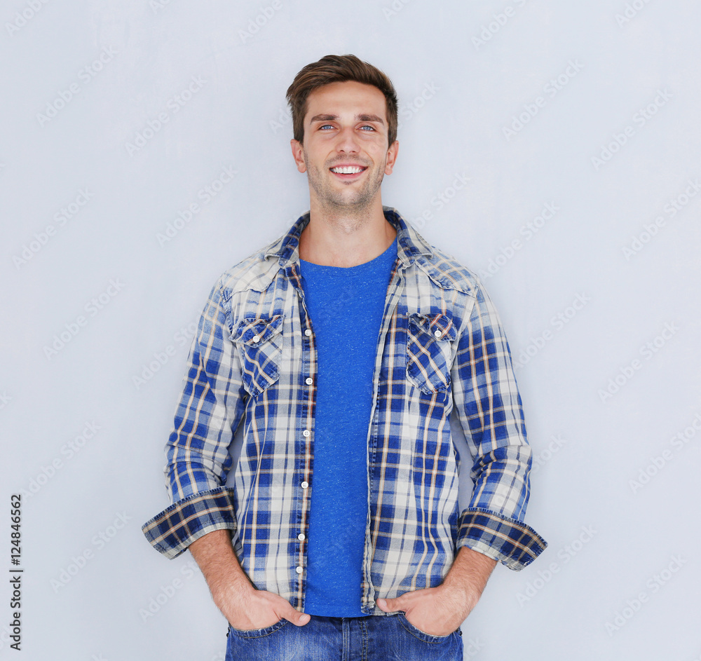 Young happy man on light background