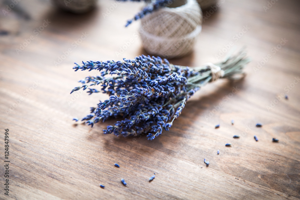bunch of lavender and spools of thread on wooden background bunch of lavender and spools of thread on wooden background