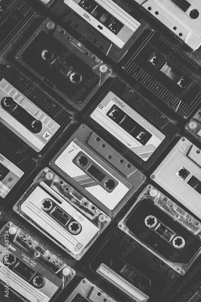 Collection of retro cassette tapes places in diagonal angle. Vintage style and filtered process. Black and White Tone.