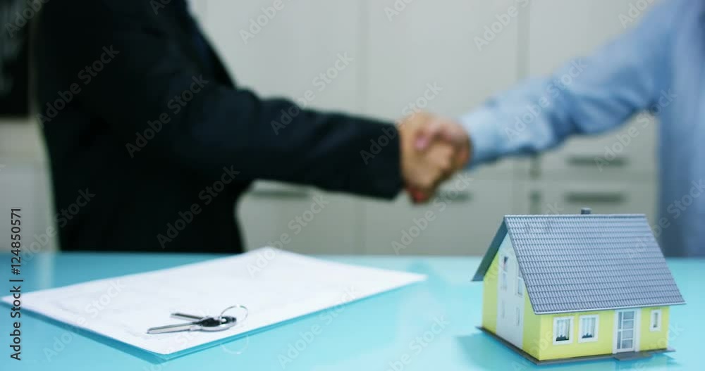 insurance and investment banking . concept of policies and safe investments without risks for investors . success hand shake house. Security for business and affordable housing for rent or sale insurance and investment banking . concept of policies and safe investments without risks for investors . success hand shake house. Security for business and affordable housing for rent or sale