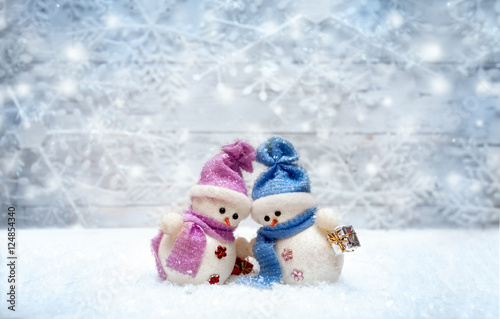 Snowman couple set against each other with snowflakes on the bac © Cherries
