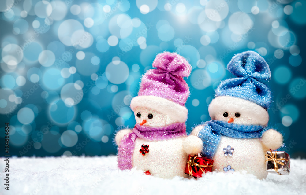 Cute snowmen couple with blue winter background