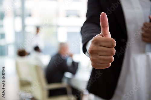 Businesswoman showing thumbs up