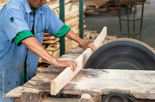 Carpenter cutting a wooden plank