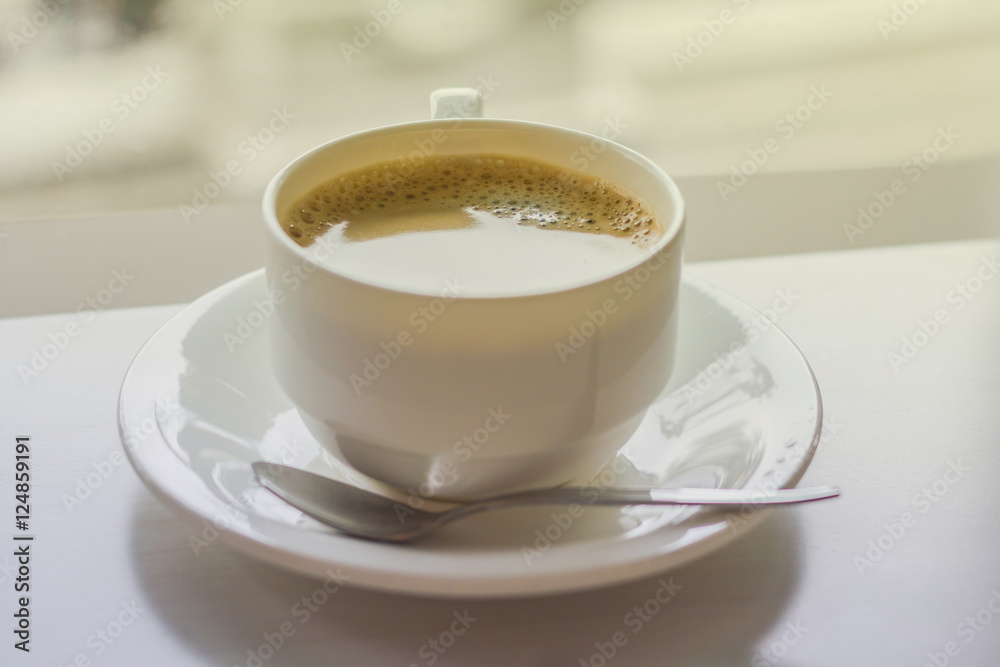 Cup of coffee on a wooden table and in coffee shop. Cup of coffee on a wooden table and in coffee shop.