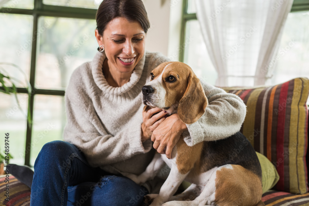 woman enjoying a cuddle with her dog at home woman enjoying a cuddle with her dog at home