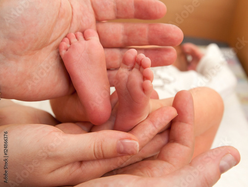 Infant heels in mother's and fathers hands