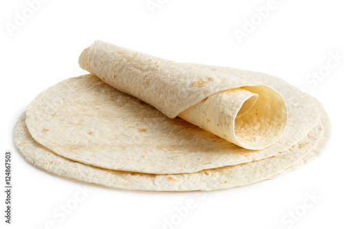 Stack of tortilla wraps and one folded wrap isolated on white. photo