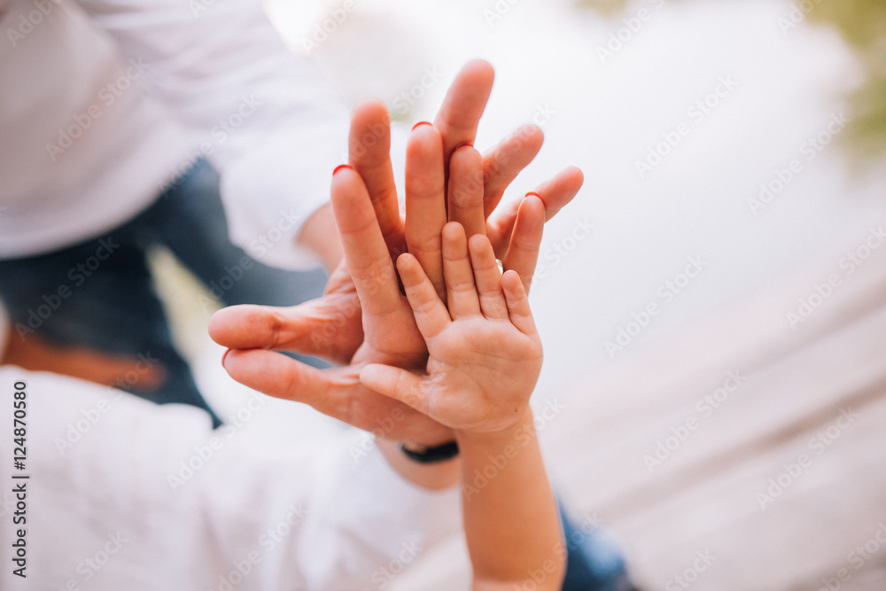People, charity, family and care concept - close up of woman hands holding girl hands