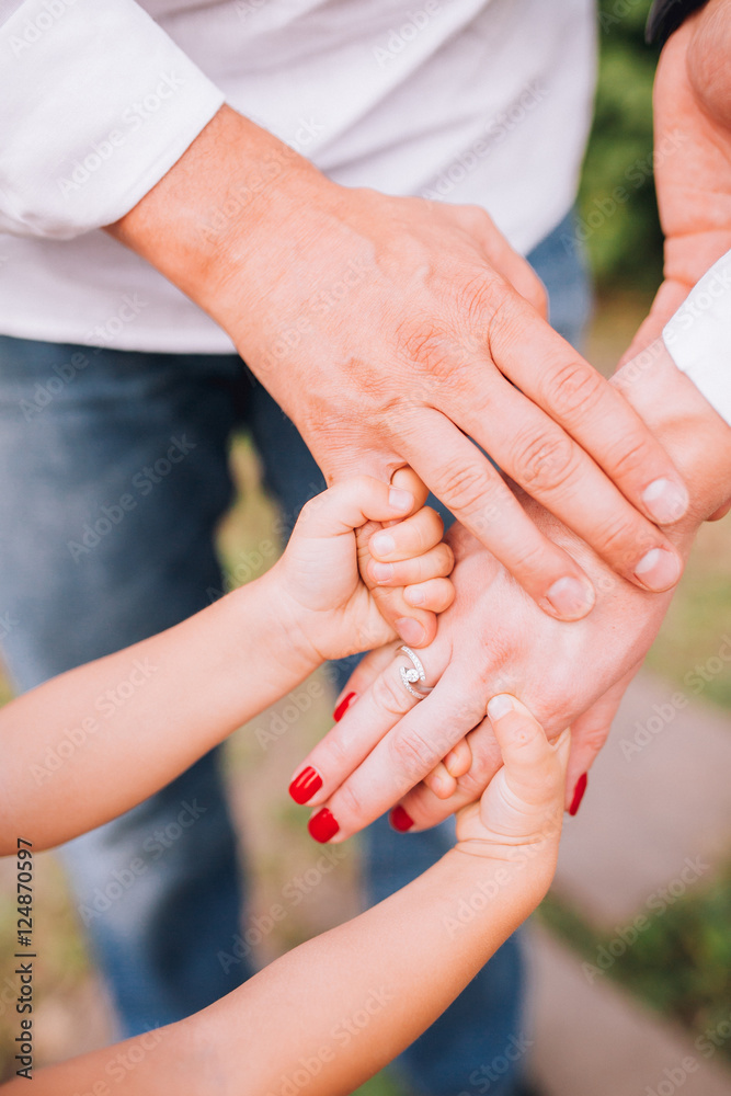 People, charity, family and care concept - close up of woman hands holding girl hands People, charity, family and care concept - close up of woman hands holding girl hands