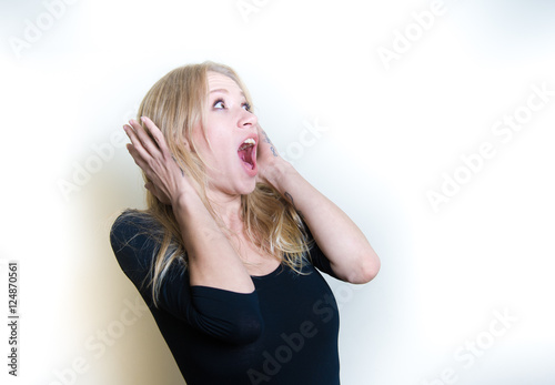 Slika na platnu Stunned young woman on white portrait