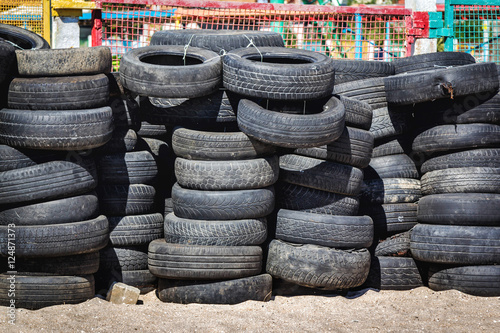 Worn, old and damaged rubber tires dumping outdoors
