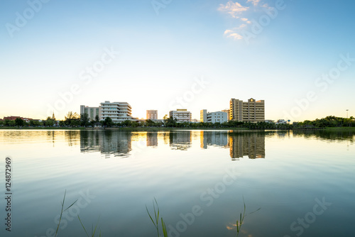 Lake in city park with skyline in background
