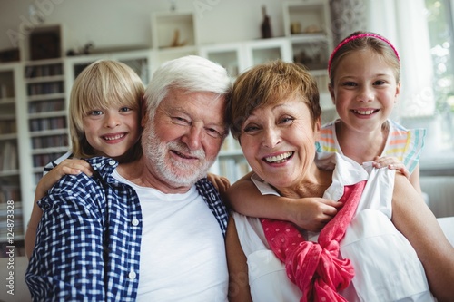 Portrait of grandparents smiling with their grandchildren photo