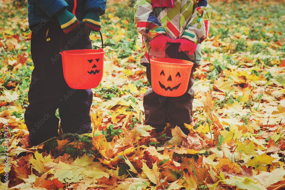 Fototapeta premium little boy and girl trick or treating in fall nature