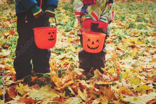 little boy and girl trick or treating in fall nature photo
