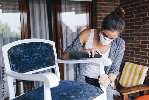 фотографія Young woman restoring a chair