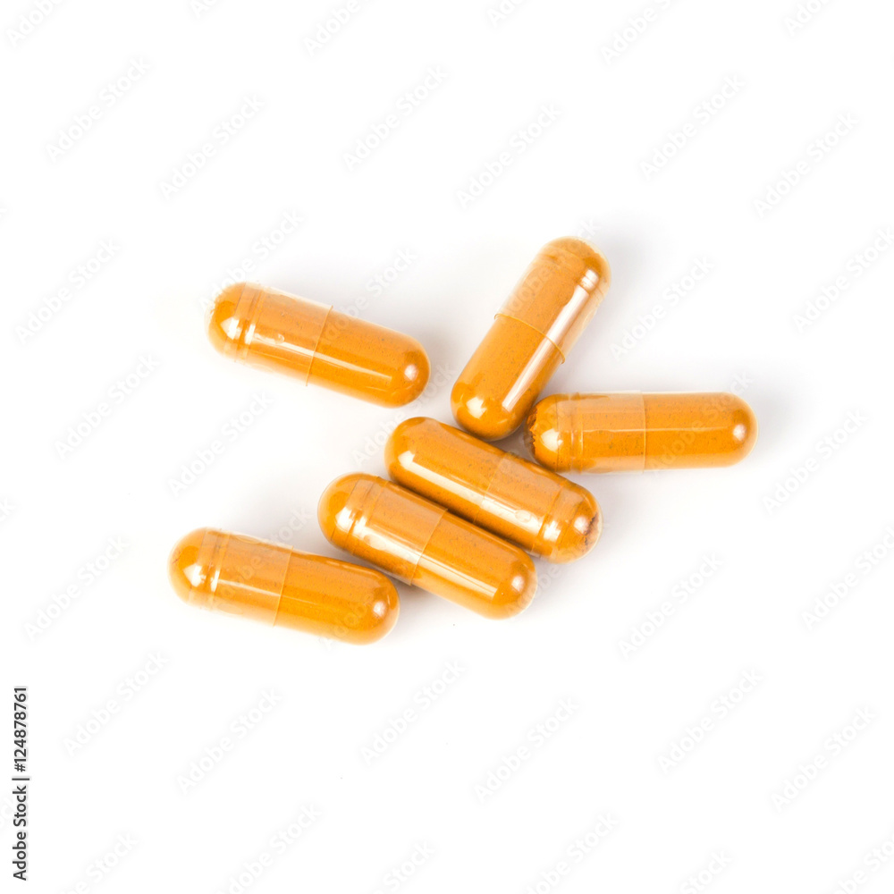 Close up turmeric capsule on white background Close up turmeric capsule on white background