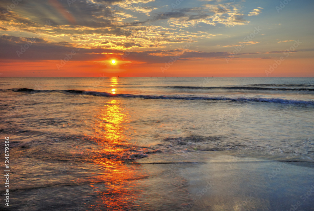 Fototapeta premium Beautiful sunrise over the sea with dramatic clouds on the sky