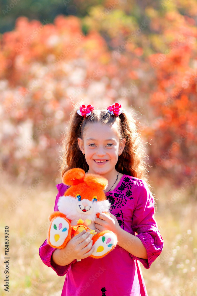 Beautiful little girl running on the grass on a summer day, with her favorite toy. Happy child playing with a toy. Beautiful little girl running on the grass on a summer day, with her favorite toy. Happy child playing with a toy.