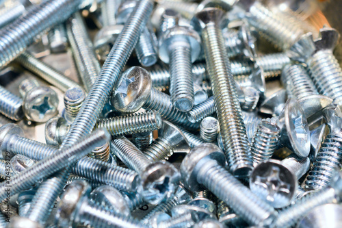 Many screws arranged as background photo