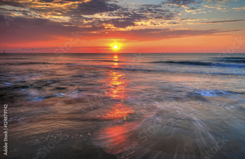 Beautiful sunrise over the sea with dramatic clouds on the sky