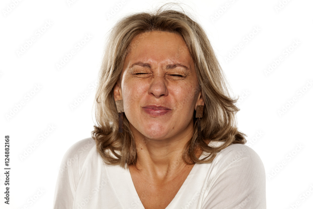 Portrait of beautiful middle-aged with sour gesture