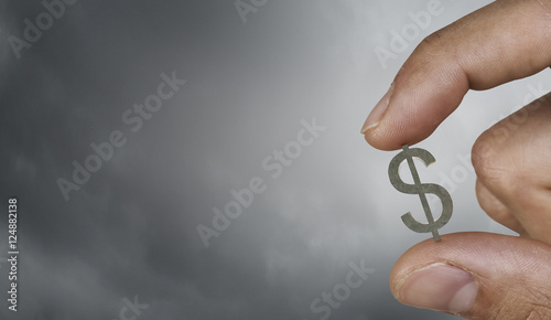 Money symbol between fingers . Mixed media photo