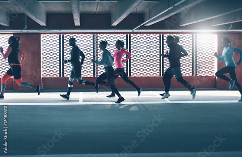 Group of diverse young people urban running