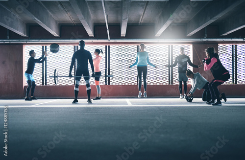 Group of diverse friends working out in town