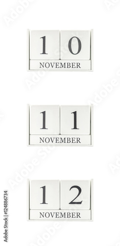 Closeup group of white wooden calendar with black 10 , 11 , 12 november word , three date calendar isolated on white background