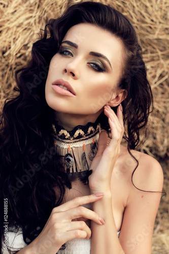 fashion outdoor photo of beautiful woman with dark hair  in casual clothes, posing on farm 