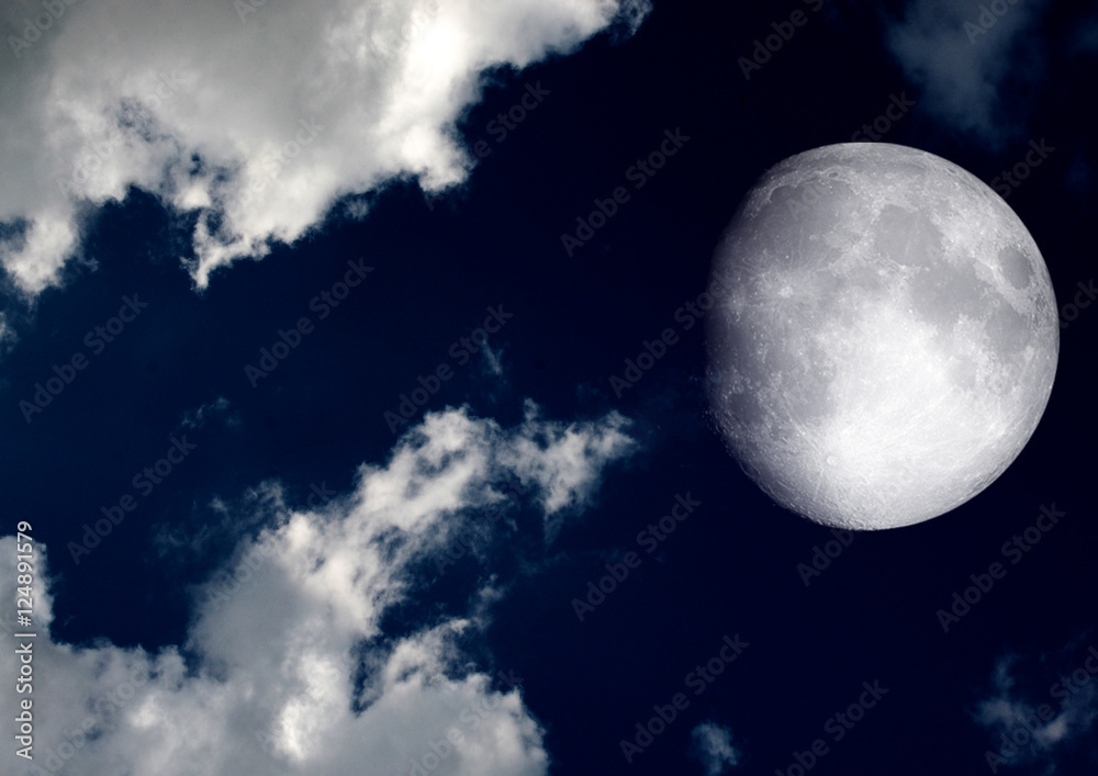 The moon in the night sky in clouds