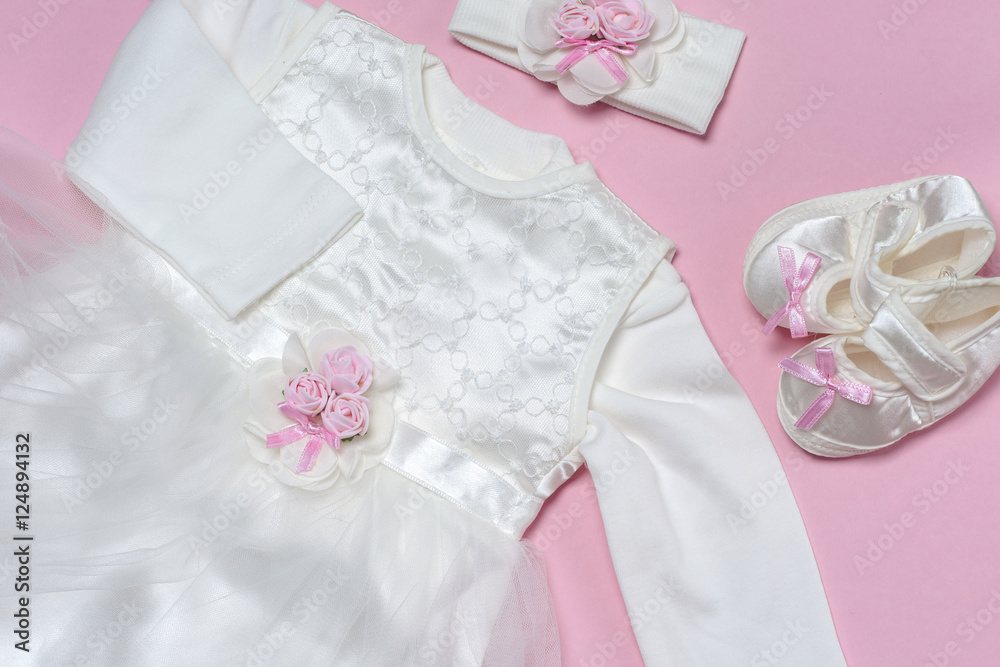 Clothes for baby girl on a pink background. Copy space Clothes for baby girl on a pink background. Copy space