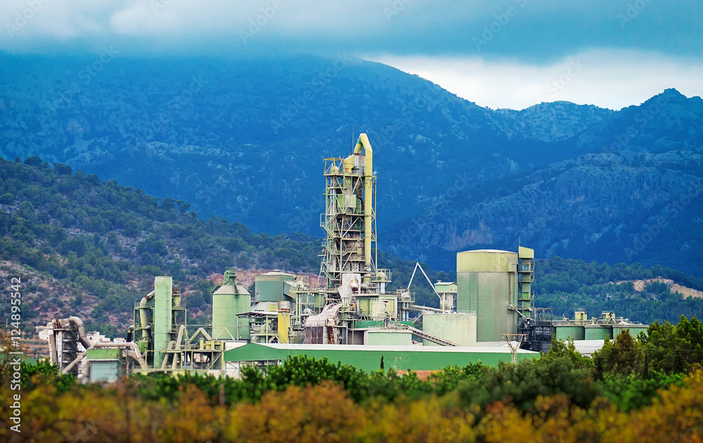 View of commercial cement factory in mountains.