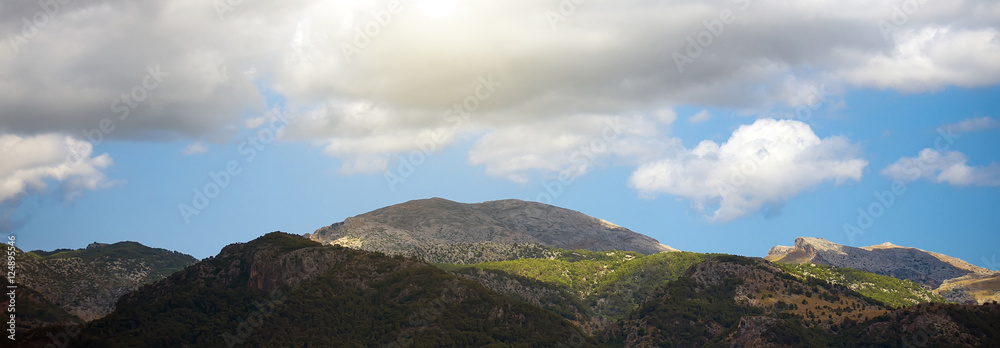 View of scenic mountains landscape with clouds.