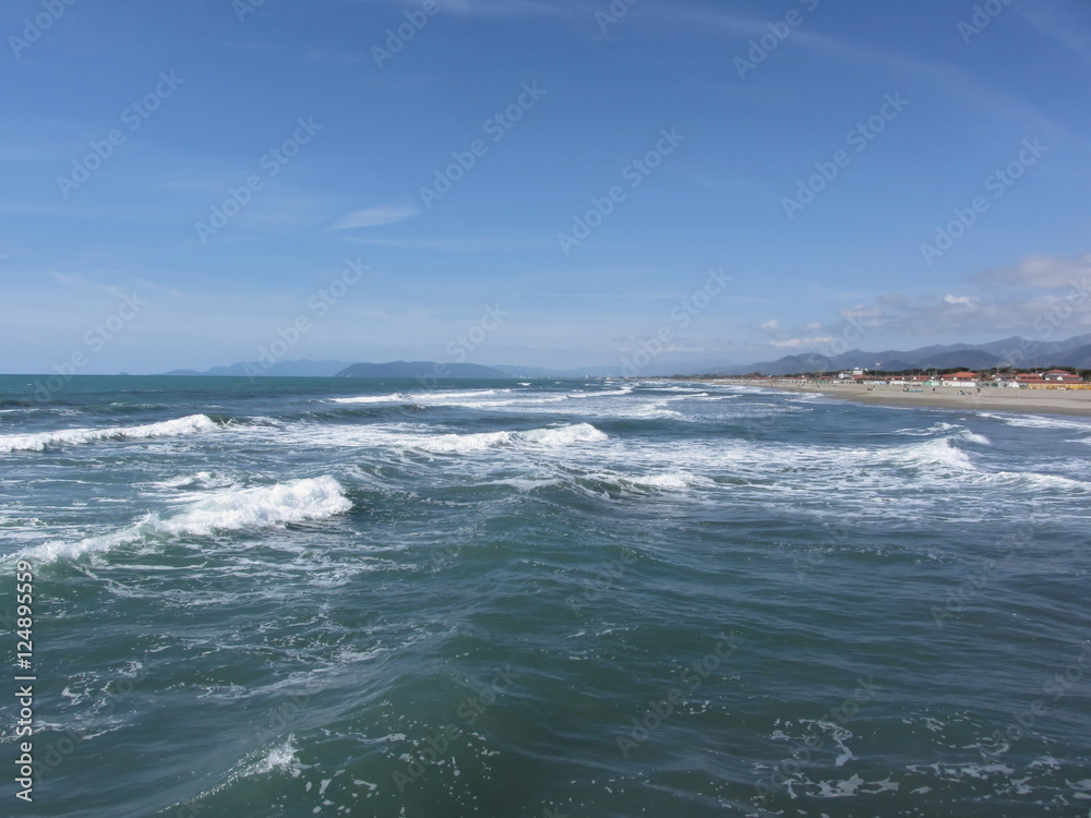 Waves of the sea on the sand beach. Forte dei marmi, Province of Lucca, Italy