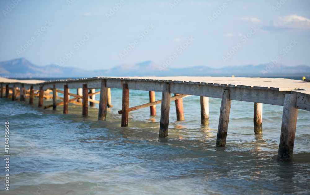Old wooden pier leading to the sea.