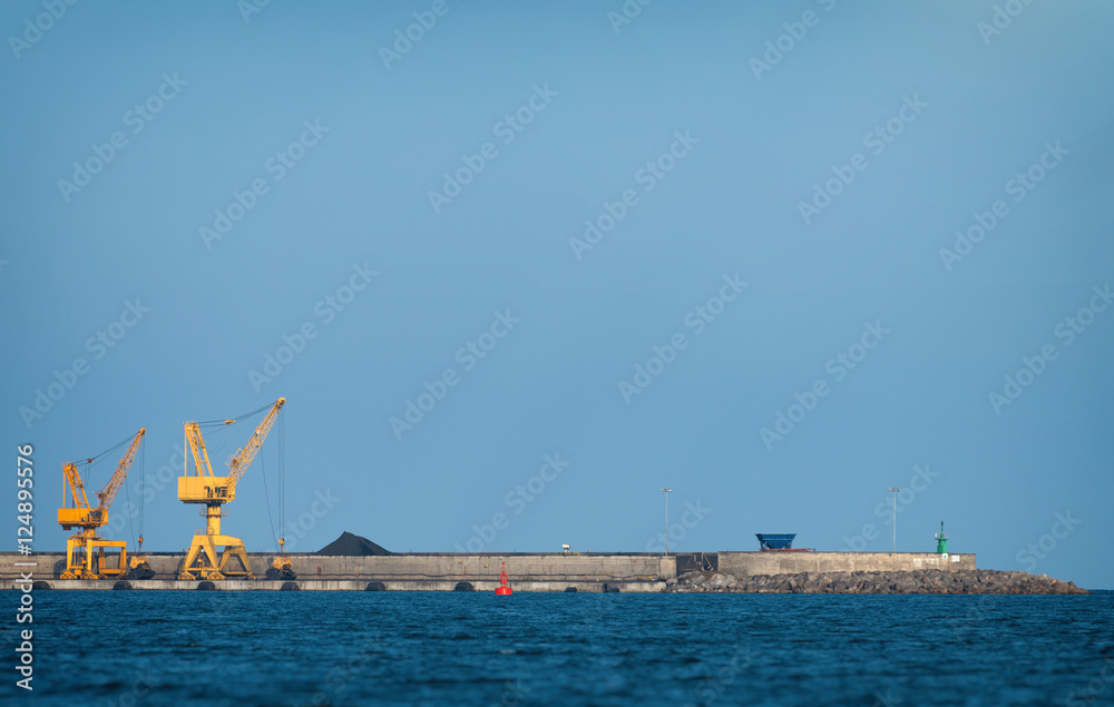 Fototapeta premium Yellow harbor cranes on rails in port.