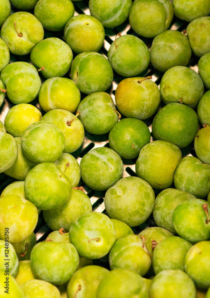 Lots of bright green plums in supermarket. Lots of bright green plums in supermarket.